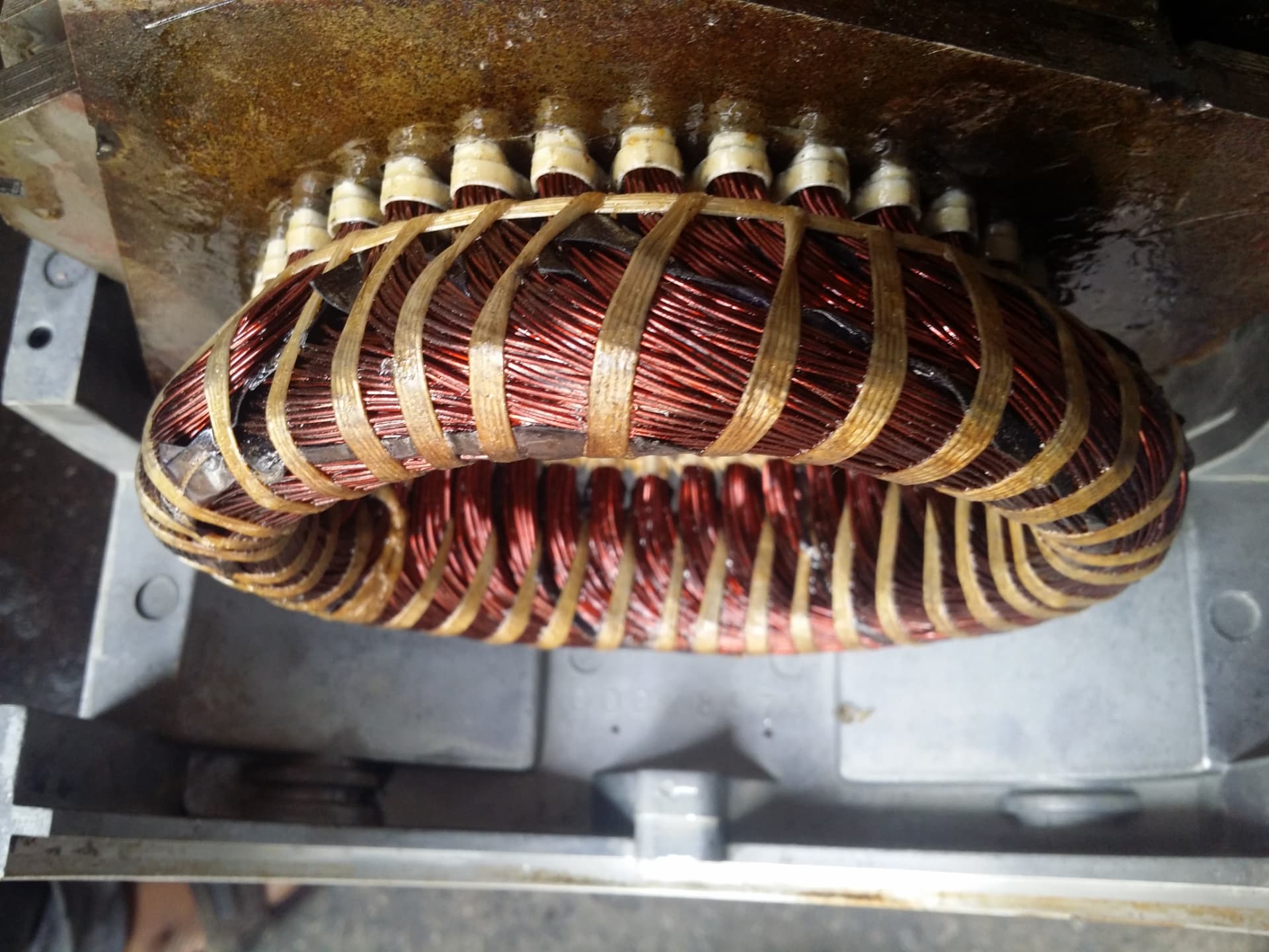 Close-up of electric motor stator windings after rewinding and varnishing