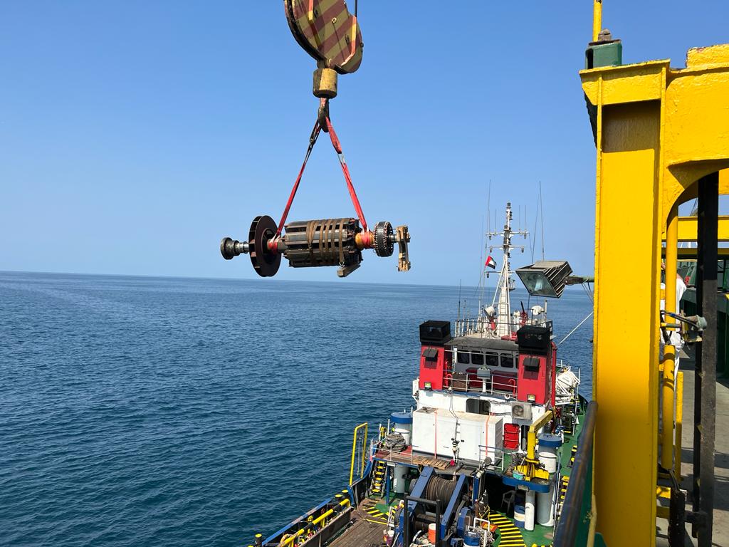 Rotor being lifted by crane over the sea onto a vessel