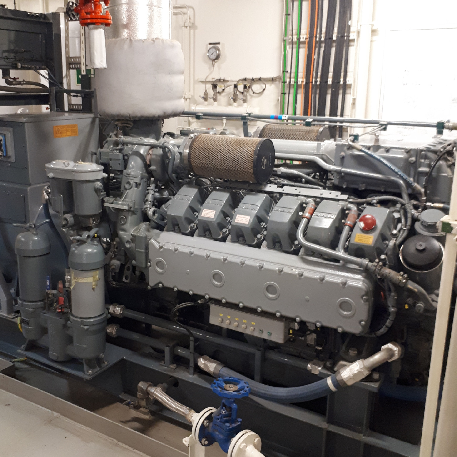 MAN marine diesel generator engine with air filters and fuel piping