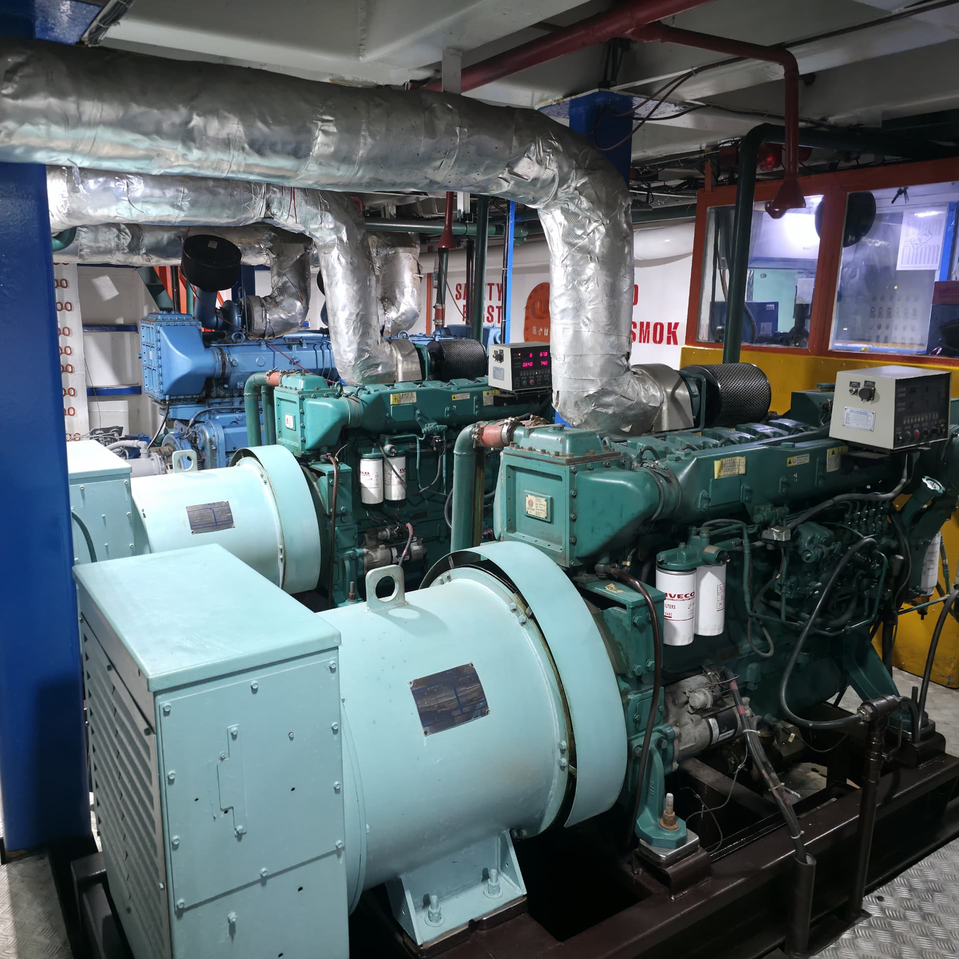 Twin marine diesel generator sets with lagged exhaust ducts in engine room