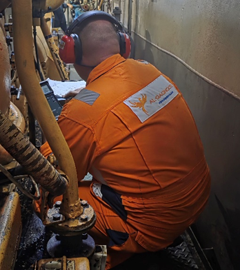 Marine engineer at engine-room automation control panel