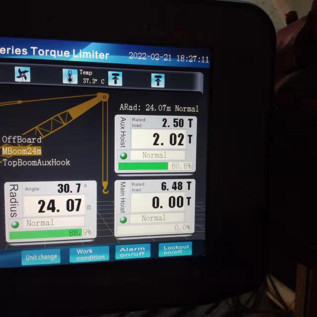 Crane torque limiter touchscreen showing main and aux hoist load, radius and angle