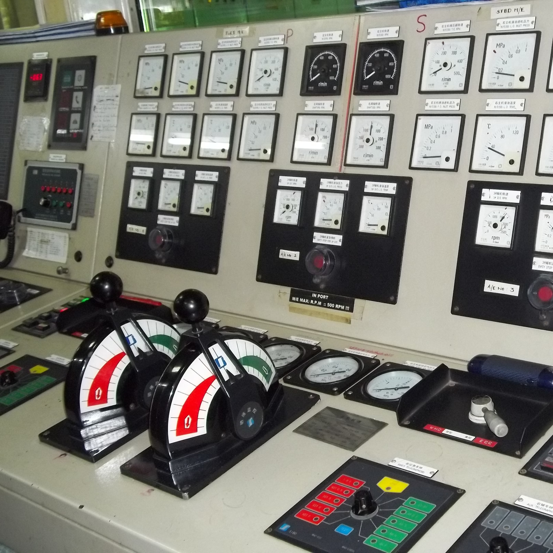 Engine control room console with dual main engine telegraphs and gauge cluster