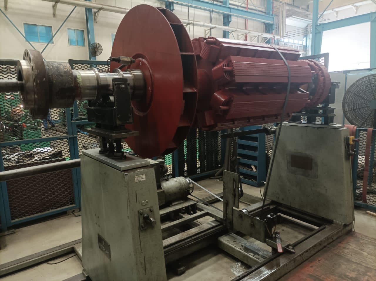 Large rotor mounted on dynamic balancing machine in workshop